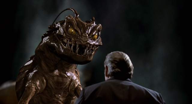 Wide shot frame from Men in Black — standing, suit, face