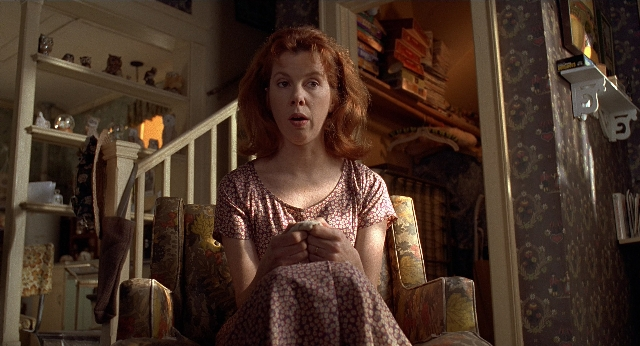 Wide shot frame from Men in Black — sitting, room, dress