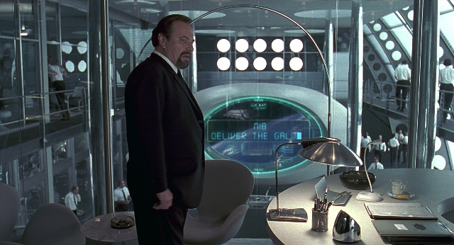 Wide shot frame from Men in Black — standing, walking, room