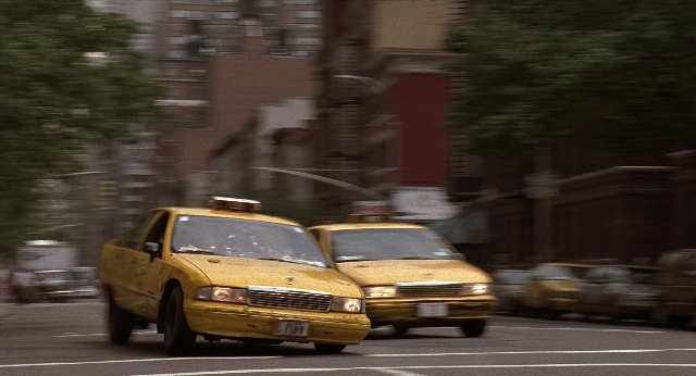 Wide shot frame from Men in Black — street, car, headlight