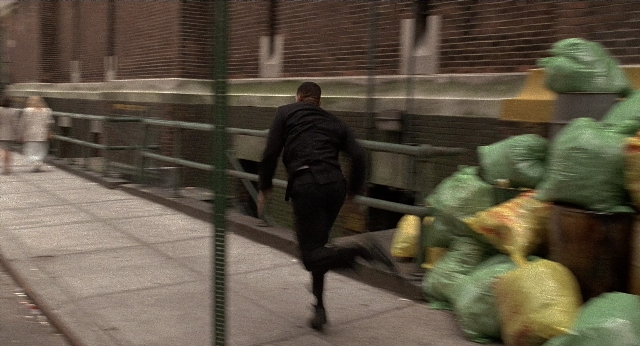 Wide shot frame from Men in Black — walking, street, person