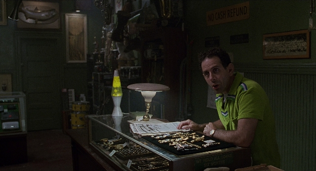 Wide shot frame from Men in Black — sitting, door, shirt