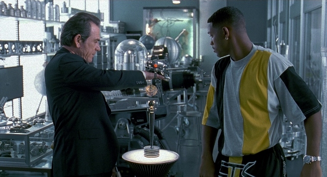 Wide shot frame from Men in Black — standing, hand, suit