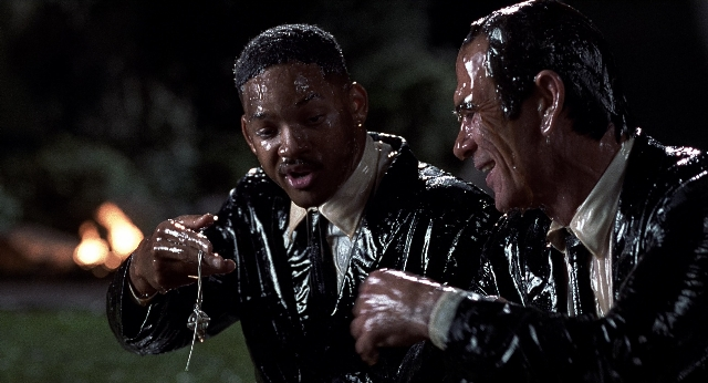 Wide shot frame from Men in Black — standing, hand, night