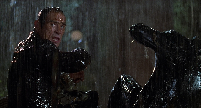 Wide shot frame from Men in Black — standing, hand, suit