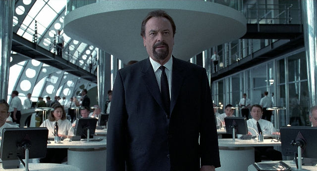 Wide shot frame from Men in Black — sitting, standing, room