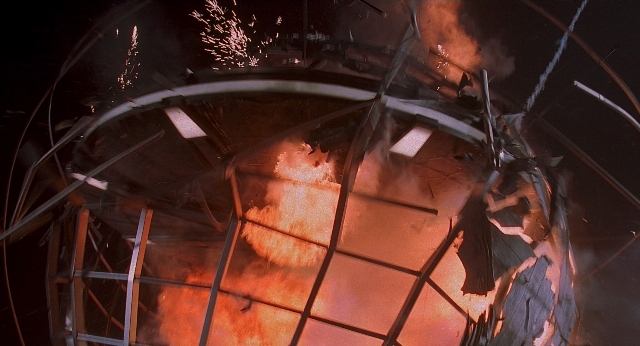 Wide shot frame from Men in Black — fire, tower, smoke
