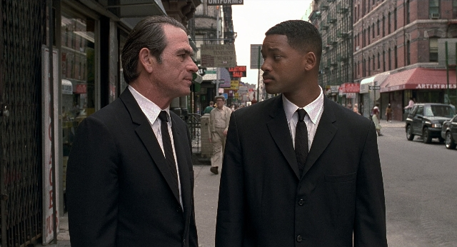 Wide shot frame from Men in Black — standing, walking, street