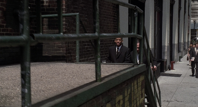 Wide shot frame from Men in Black — standing, walking, street