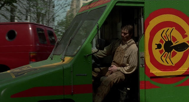 Wide shot frame from Men in Black — sitting, face, bird