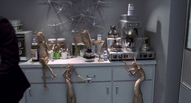 Wide shot frame from Men in Black — kitchen, bottle, person