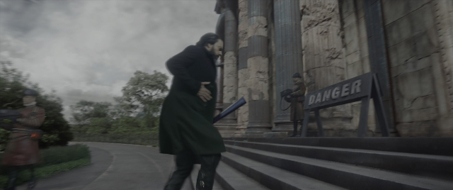 Wide shot frame from Mortal Engines — walking, street, coat
