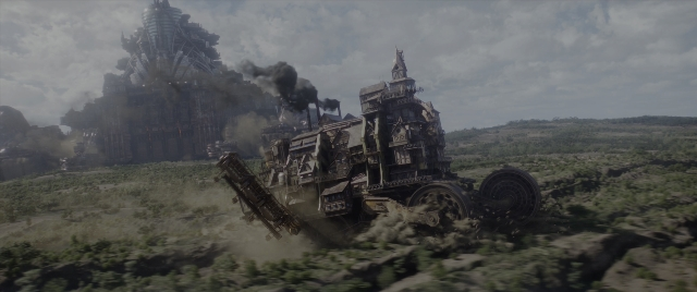 Wide shot frame from Mortal Engines — smoke, wheel, land vehicle