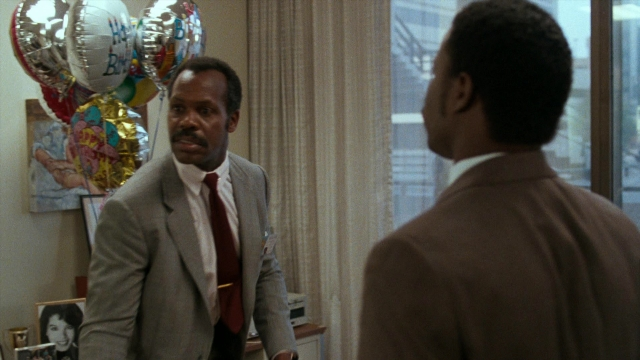Wide shot frame from Lethal Weapon — room, dialogue, suit
