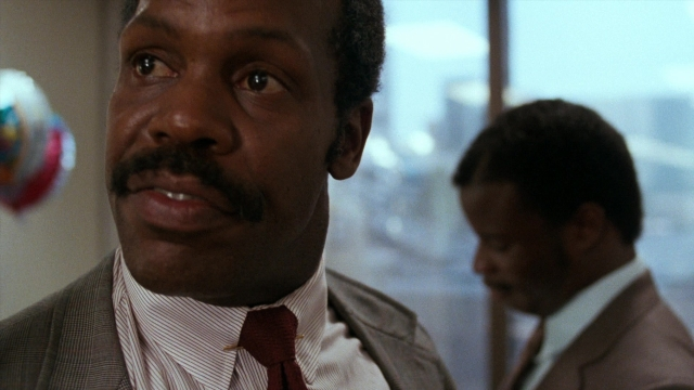 Wide shot frame from Lethal Weapon — room, suit, tie