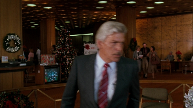 Wide shot frame from Lethal Weapon — walking, suit, tie