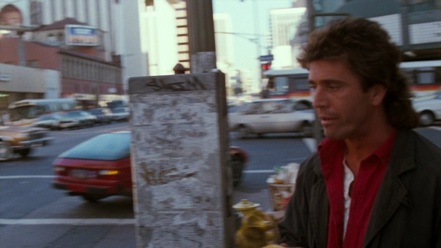 Frame from Lethal Weapon — standing, street, fire