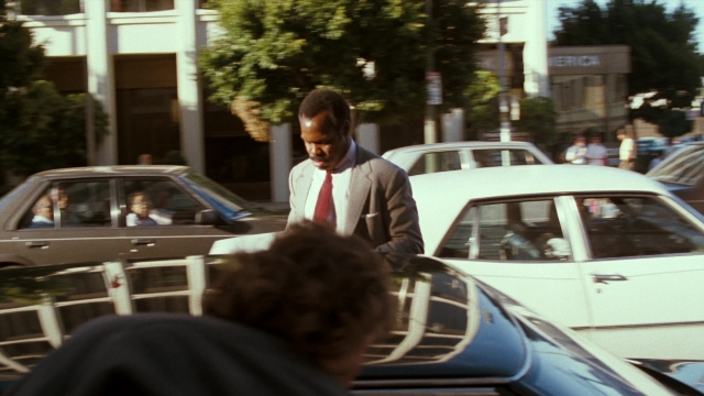 Wide shot frame from Lethal Weapon — standing, walking, street