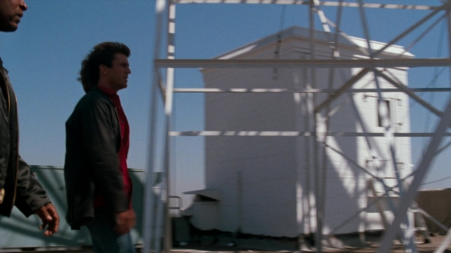 Wide shot frame from Lethal Weapon — standing, dialogue, person