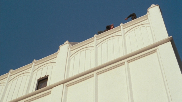 Frame from Lethal Weapon — standing, person, window