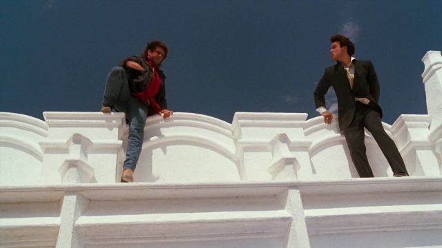 Wide shot frame from Lethal Weapon — standing, suit, tie