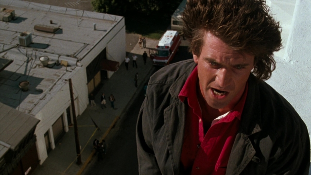 Medium shot frame from Lethal Weapon — standing, street, fire