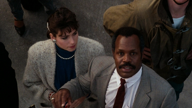 Medium shot frame from Lethal Weapon — standing, dialogue, hand