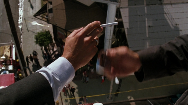 Wide shot frame from Lethal Weapon — walking, street, suit