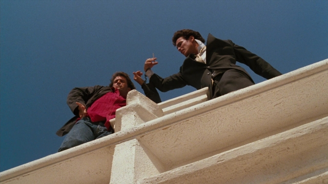 Wide shot frame from Lethal Weapon — standing, hand, suit