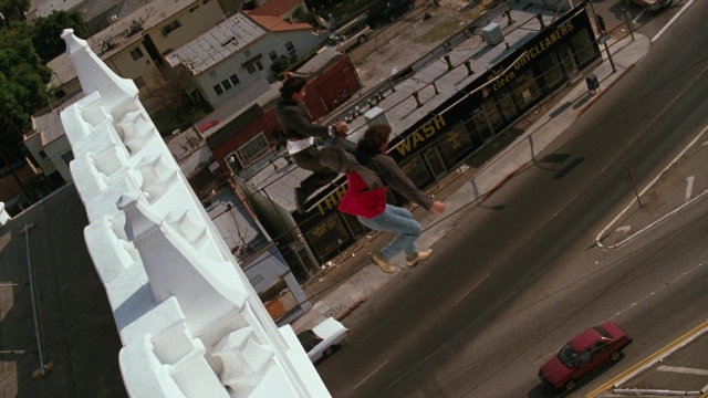 Frame from Lethal Weapon — standing, street, car