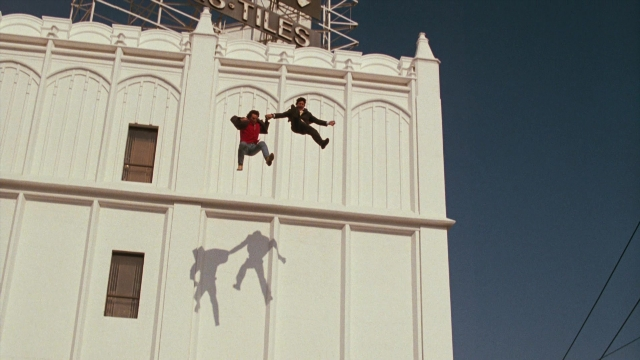 Wide shot frame from Lethal Weapon — person, smiling, window