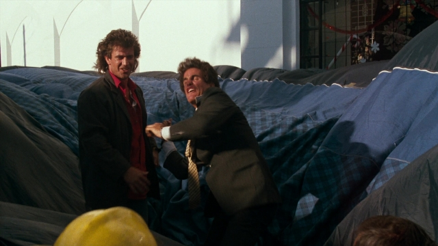 Wide shot frame from Lethal Weapon — standing, room, dialogue