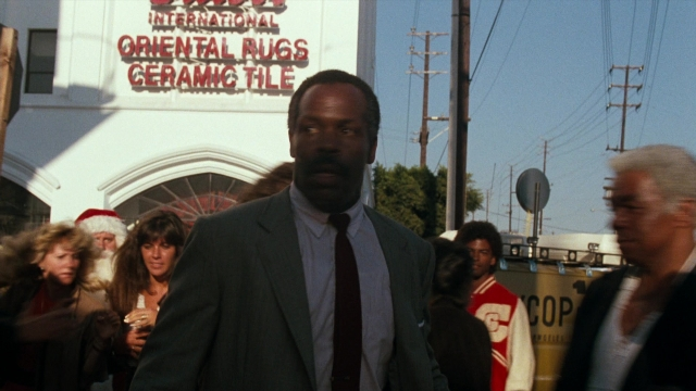 Wide shot frame from Lethal Weapon — walking, street, suit