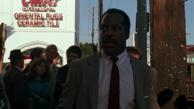 Wide shot frame from Lethal Weapon — walking, street, suit