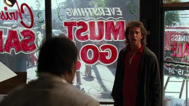 Wide shot frame from Lethal Weapon — standing, room, dialogue
