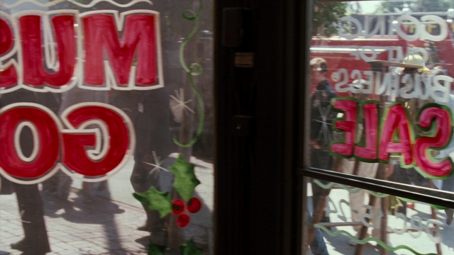 Wide shot frame from Lethal Weapon — walking, door, street