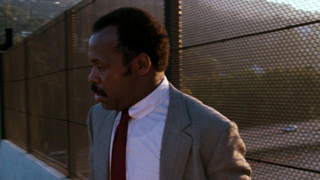 Medium shot frame from Lethal Weapon — standing, suit, tie