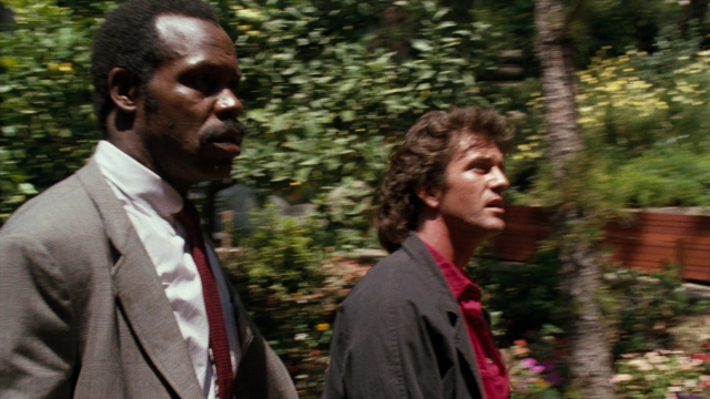 Wide shot frame from Lethal Weapon — walking, suit, tie