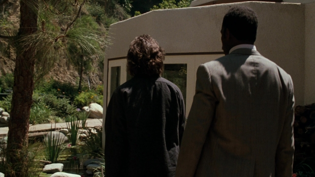 Wide shot frame from Lethal Weapon — standing, dialogue, coat