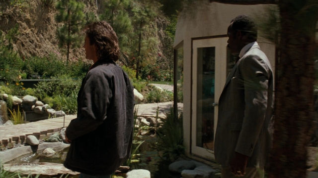 Frame from Lethal Weapon — standing, door, coat