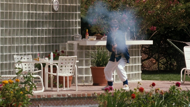 Wide shot frame from Lethal Weapon — standing, table, house