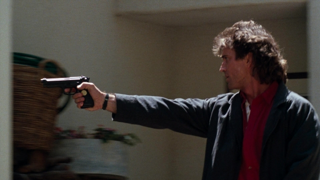 Wide shot frame from Lethal Weapon — standing, room, kitchen