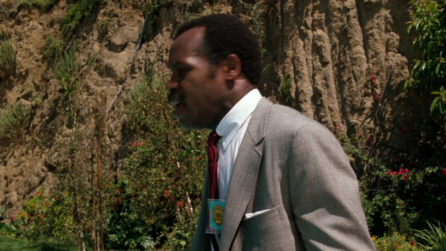 Wide shot frame from Lethal Weapon — walking, suit, tie