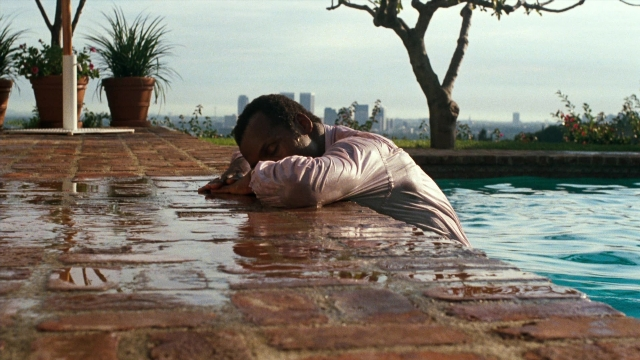 Wide shot frame from Lethal Weapon — shirt, water, person