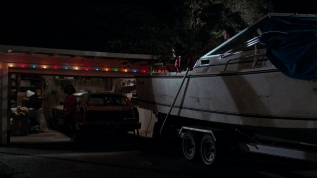 Wide shot frame from Lethal Weapon — standing, car, night