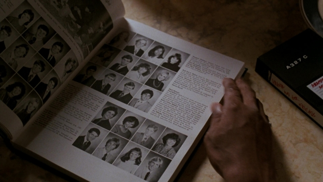 Frame from Lethal Weapon — book, table, hand