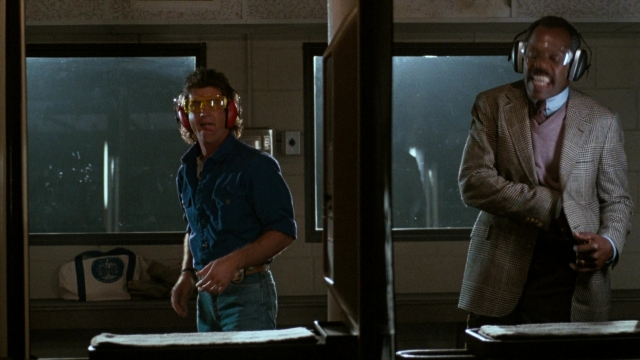Wide shot frame from Lethal Weapon — standing, room, dialogue