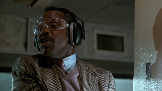 Frame from Lethal Weapon — standing, room, suit