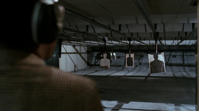 Wide shot frame from Lethal Weapon — standing, room, suit