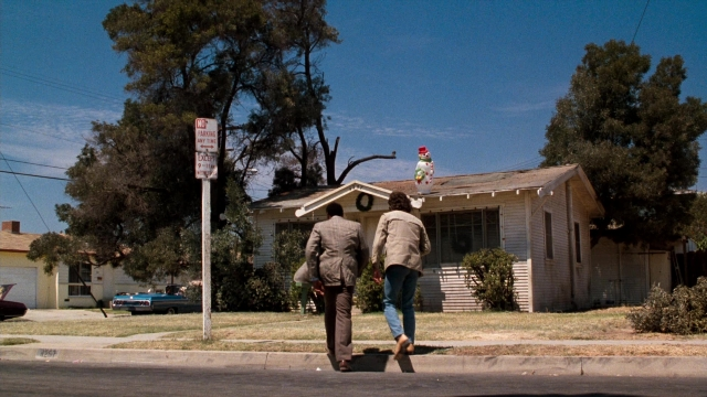 Wide shot frame from Lethal Weapon — walking, street, house